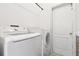 This laundry room features a modern, front-loading washer and dryer for convenient and efficient laundry care at 1727 Woodpond Way, Lutz, FL 33559
