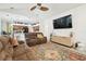 Open concept living room with a large flat screen tv, vaulted ceilings, and neutral paint colors at 1727 Woodpond Way, Lutz, FL 33559