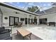 Spacious covered patio featuring white siding, ceiling fans and dark trim accents at 1727 Woodpond Way, Lutz, FL 33559