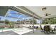 Covered patio featuring a pool, seating and dining area at 1727 Woodpond Way, Lutz, FL 33559