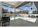 Screened patio features a built in pool, seating, and a grill at 1727 Woodpond Way, Lutz, FL 33559