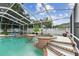 Beautiful screened pool and spa featuring brick accents and a waterfall feature at 1727 Woodpond Way, Lutz, FL 33559