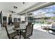 Covered patio area featuring an outdoor dining area, seating and a pool at 1727 Woodpond Way, Lutz, FL 33559