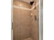 Shower stall featuring tile walls with decorative accents, complete with a shower head and faucet at 1727 Woodpond Way, Lutz, FL 33559