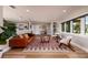 Inviting living room with hardwood floors, leather couch, and large window providing lots of light at 2096 Tanglewood Ne Way, St Petersburg, FL 33702