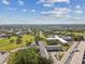 Elevated aerial view shows building, parking, golf course, pond and neighborhood at 2430 Florentine Way # 46, Clearwater, FL 33763