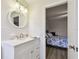 Bathroom featuring a white vanity with sink, a round mirror, and decorative lighting at 2430 Florentine Way # 46, Clearwater, FL 33763
