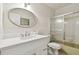 Bathroom featuring a modern vanity with an oval mirror and a shower-tub combo at 2430 Florentine Way # 46, Clearwater, FL 33763