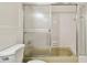 Bathtub-shower with glass sliding doors and tiled surround at 2430 Florentine Way # 46, Clearwater, FL 33763