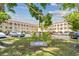 Exterior view of building, with beautifully maintained landscaping and parking at 2430 Florentine Way # 46, Clearwater, FL 33763