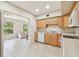 Kitchen and eat in space with light wood cabinetry and white appliances at 2430 Florentine Way # 46, Clearwater, FL 33763