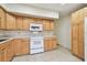 Cozy kitchen with white appliances and light wood cabinetry at 2430 Florentine Way # 46, Clearwater, FL 33763