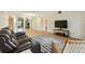 Large living room with hardwood flooring, plush sofa, and view to bedroom at 2430 Florentine Way # 46, Clearwater, FL 33763