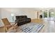 Bright living room features a comfortable sofa, rocking chair, and view to dining area at 2430 Florentine Way # 46, Clearwater, FL 33763