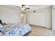 Spacious main bedroom with vinyl floors, a ceiling fan, a large closet, and a sliding glass door at 2430 Florentine Way # 46, Clearwater, FL 33763