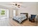 Comfortable main bedroom featuring vinyl flooring, a ceiling fan, and access to the ensuite bathroom at 2430 Florentine Way # 46, Clearwater, FL 33763