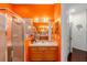 Bright bathroom with orange walls, vanity with generous countertop and a glass shower at 2539 Centennial Falcon Dr, Valrico, FL 33596