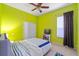 Bright bedroom with light green walls, ceiling fan, and a cozy gray chair at 2539 Centennial Falcon Dr, Valrico, FL 33596