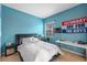 Modern bedroom with blue walls, large desk, and a comfortable bed at 2539 Centennial Falcon Dr, Valrico, FL 33596