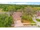 Aerial view of a beautiful home featuring a large lawn, mature trees, and an attached two-car garage at 2539 Centennial Falcon Dr, Valrico, FL 33596