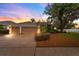 Charming single-story home featuring a manicured front lawn, mature tree, and a three-car garage at 2539 Centennial Falcon Dr, Valrico, FL 33596