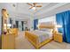 Spacious main bedroom features tray ceilings, columns, and a ceiling fan for added comfort at 2539 Centennial Falcon Dr, Valrico, FL 33596