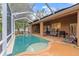 Relaxing screened-in pool area perfect for entertaining, with ample seating and outdoor grill at 2539 Centennial Falcon Dr, Valrico, FL 33596