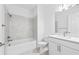 Bright bathroom with a tub and shower combination and a white vanity at 27148 Capri Shores Cir, Englewood, FL 34223