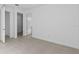 Bright bedroom with tile floors, open doorways to closet space and bathroom at 27148 Capri Shores Cir, Englewood, FL 34223