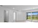 Bright living room with tile floors, sliding glass doors opening to a screened lanai and lake views at 27148 Capri Shores Cir, Englewood, FL 34223