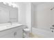 Bright bathroom featuring a shower-over-tub, and a white vanity with a modern faucet at 27152 Capri Shores Cir, Englewood, FL 34223