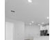 Bright living room area featuring recessed lighting and connecting to the kitchen area at 27152 Capri Shores Cir, Englewood, FL 34223