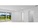 Bright living room area featuring sliding glass doors with a screened lanai and a view at 27152 Capri Shores Cir, Englewood, FL 34223