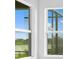 Bright natural light fills the living room through the expansive windows with neighborhood views at 27152 Capri Shores Cir, Englewood, FL 34223