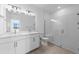 Modern bathroom with double vanity, quartz countertop, glass shower, and neutral tiling at 27156 Capri Shores Cir, Englewood, FL 34223