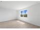 Bright bedroom with neutral-toned tile floors and large window with views of palms at 27156 Capri Shores Cir, Englewood, FL 34223