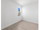 Bright bedroom features neutral walls, light tile floors, and a large window for ample natural light at 27156 Capri Shores Cir, Englewood, FL 34223