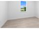 Bright bedroom features neutral walls, light tile floors, and a large window for ample natural light at 27156 Capri Shores Cir, Englewood, FL 34223