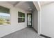 The entrance is framed by two windows and boasts a black door, and paver flooring at 27156 Capri Shores Cir, Englewood, FL 34223
