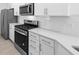A well appointed kitchen features granite countertops and stainless steel appliances at 27156 Capri Shores Cir, Englewood, FL 34223