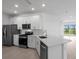Modern kitchen with stainless steel appliances, white cabinets, and an island at 27156 Capri Shores Cir, Englewood, FL 34223