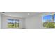 The living room features large windows to take in the view, and sliding glass doors to the outside at 27156 Capri Shores Cir, Englewood, FL 34223