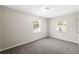 Neutral bedroom featuring soft gray carpet, two windows, and a neutral paint at 2916 E North St, Tampa, FL 33610