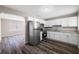 Modern kitchen featuring stainless steel appliances, granite countertops, and white cabinetry at 2916 E North St, Tampa, FL 33610
