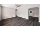 Spacious living room featuring dark hardwood flooring and a ceiling fan at 2916 E North St, Tampa, FL 33610