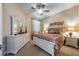 Bedroom features neutral decor, white dresser and accents, and natural light at 305 Bluewater Falls Ct, Apollo Beach, FL 33572
