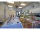 Spacious craft room with lots of tables, chairs, and cabinets at 305 Bluewater Falls Ct, Apollo Beach, FL 33572