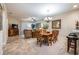 Dining room area showcases wooden table set, chandelier lighting, and open-concept layout at 305 Bluewater Falls Ct, Apollo Beach, FL 33572