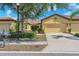 Charming single-Gathering home featuring a tile roof, two-car garage, and meticulously landscaped front yard at 305 Bluewater Falls Ct, Apollo Beach, FL 33572