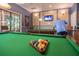 Inviting game room with a billiards table, television, and comfortable seating for relaxation and entertainment at 305 Bluewater Falls Ct, Apollo Beach, FL 33572